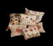 A group of six various needlework cushions