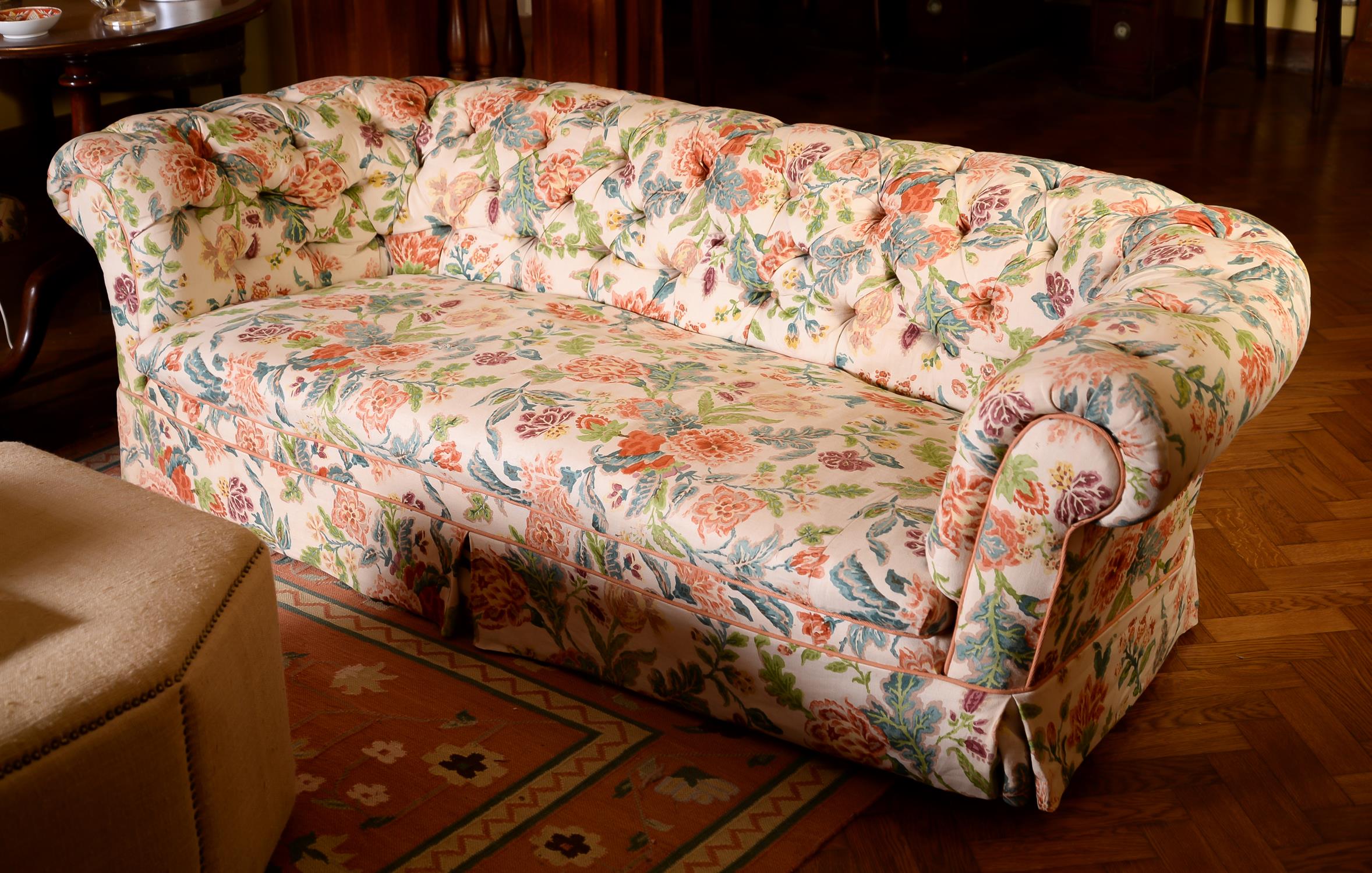 A matched pair of Victorian mahogany and button upholstered sofas