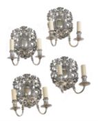 Two similar pairs of silvered metal twin light wall sconces in William & Mary taste