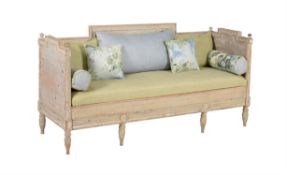 A distressed pine and upholstered sofa