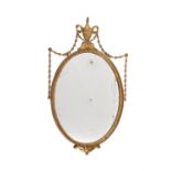 A giltwood and composition oval wall mirror