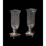 A pair of late Victorian or Edwardian glass and silver plated metal storm lanterns