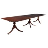 A mahogany triple pillar extending dining table