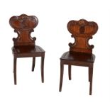 A pair of George IV mahogany hall chairs