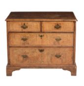 A walnut and feather banded chest of drawers