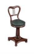 A late Regency mahogany music seat