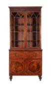 A Regency mahogany and crossbanded secretaire bookcase