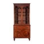 A Regency mahogany and crossbanded secretaire bookcase