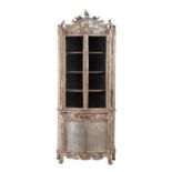 A Continental carved and silver painted display cabinet