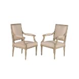 A pair of French cream painted and upholstered open armchairs