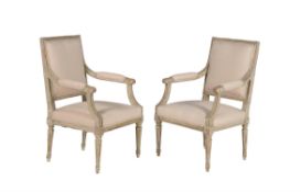 A pair of French cream painted and upholstered open armchairs