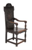 A carved oak wainscot chair in 17th century style