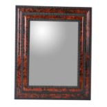 A faux tortoiseshell veneered wall mirror in 17th century style