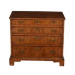A walnut chest of drawers in George II style