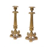 A pair of Louis Philippe gilt bronze and brass candlesticks