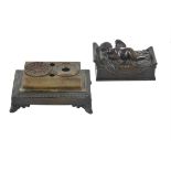 A Charles X patinated bronze figural inkwell modelled with a sleeping Cupid