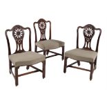 A set of three George III mahogany dining chairs