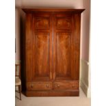 A Regency mahogany and brass strung wardrobe