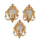 A set of three gilt metal three light girandoles in Regence style