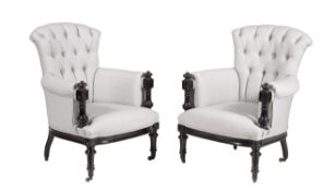 A pair of Victorian ebonised and button upholstered armchairs