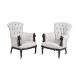 A pair of Victorian ebonised and button upholstered armchairs