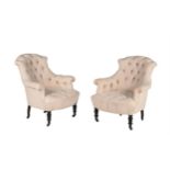 A pair of French ebonised and button upholstered armchairs