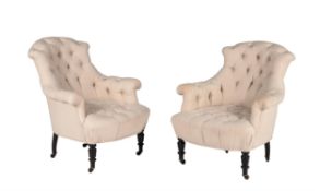 A pair of French ebonised and button upholstered armchairs