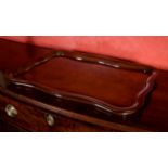 A mahogany serpentine sided tray