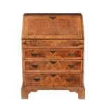 A walnut and feather banded bureau