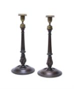 A pair of late George III turned mahogany and brass mounted candlesticks