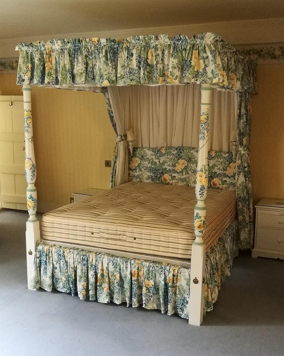 A cream and polychrome painted four poster bed in George III style