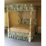 A cream and polychrome painted four poster bed in George III style
