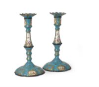 A pair of English enamelled copper candlesticks