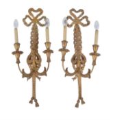 A pair of carved and giltwood twin light wall appliques
