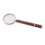 A leather and gold mounted magnifying glass