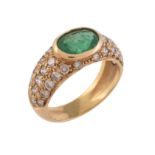 A diamond and emerald dress ring