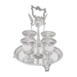 A silver circular four cup egg stand by Thomas Bradbury & Sons