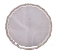 An Edwardian silver shaped circular salver by Fordham & Faulkner