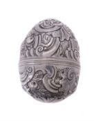 A silver coloured egg shaped nutmeg grater