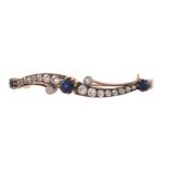 An antique sapphire and diamond crossover brooch