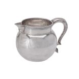 A silver baluster cream jug by Edward Barnard & Sons Ltd.
