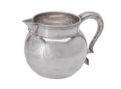 A silver baluster cream jug by Edward Barnard & Sons Ltd.