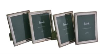 A set of four silver mounted photo frames by Harrod's Ltd.