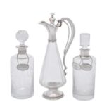A cylindrical etched glass decanter with silver coloured mounted collar