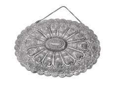 An Ottoman silver coloured shaped oval mirror