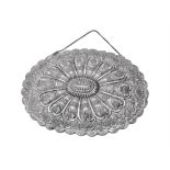 An Ottoman silver coloured shaped oval mirror