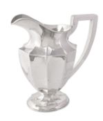 An American silver panelled oval footed water pitcher or jug by The Sweetser Co.