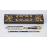A cased 19th century enamel and gilt metal dip pen and letter opener