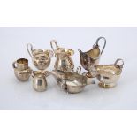 A collection of silver cream jugs