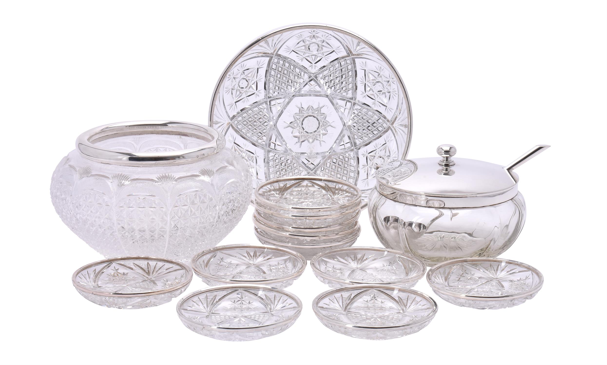 A French silver rimmed cut glass serving plate and eleven dessert plates